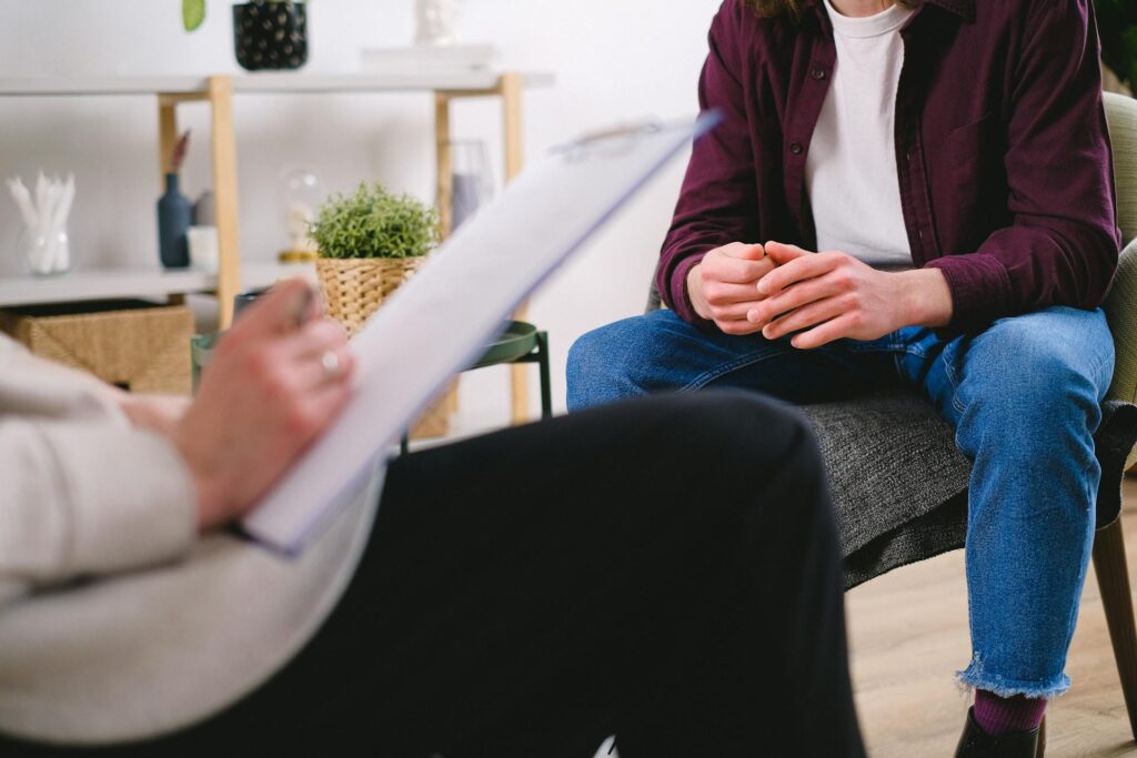 A close-up of a therapist and a patient consulting over a midlife crisis