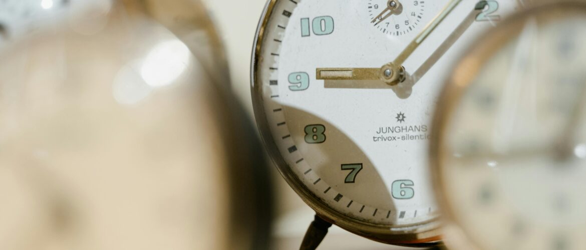 Several clocks blurred, one clock in focus, symbolising the doubt in the question Can I have a midlife crisis in my 30s?